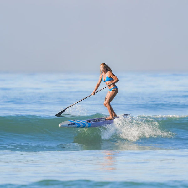 SUP girl surfing a race sup board