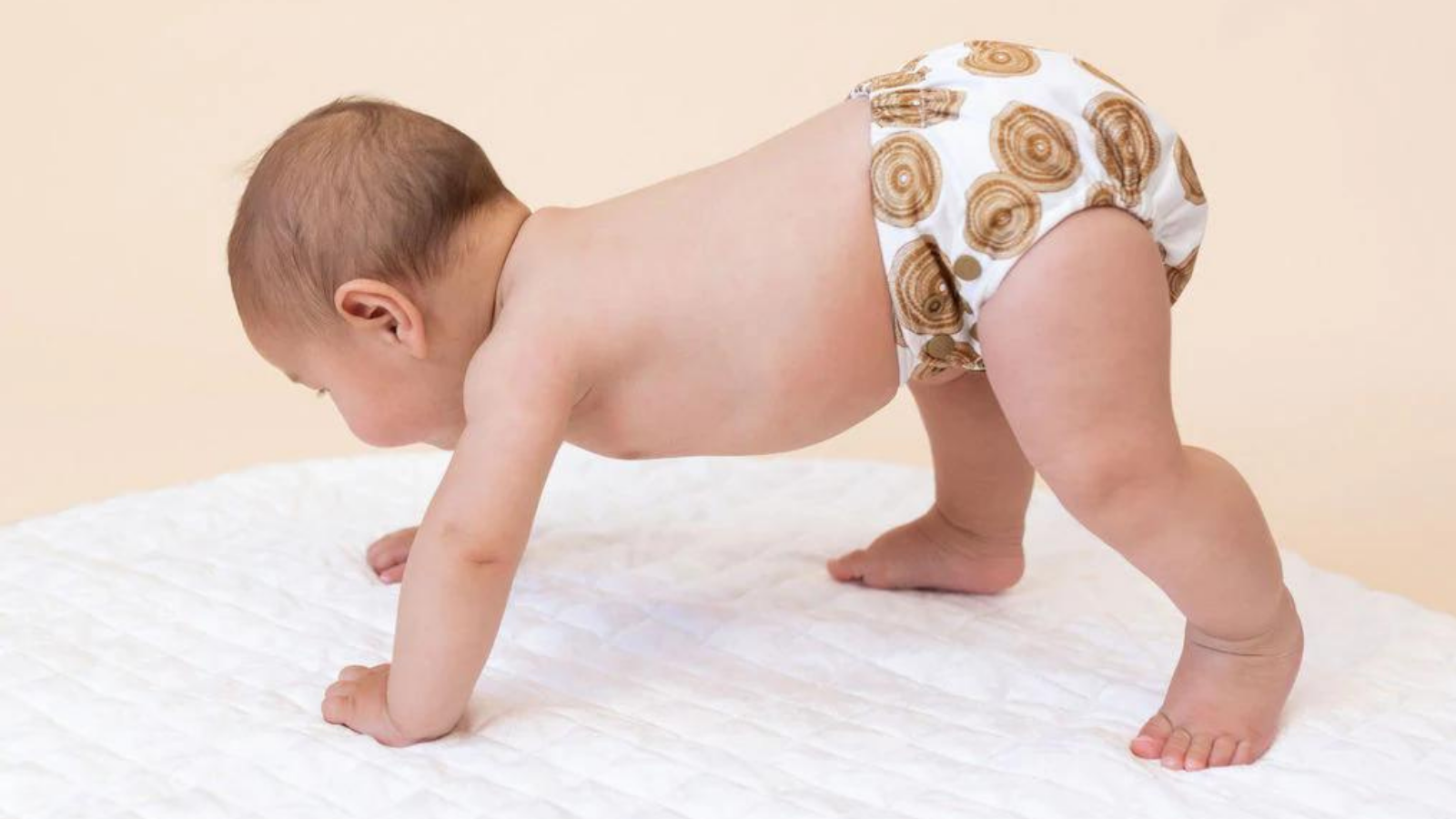 Image of a baby wearing a Bare and Boho Soft Cover Nappy in the Gugin Bujerum design