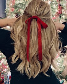 Woman with Long Blonde Hair in a Red Bow