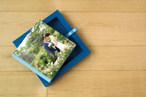 A top down image of a couple's photo album closed on top of the box