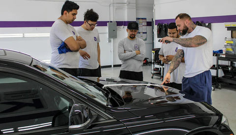 Image of group of technicians at Sigma Kore working on a ceramic coating Denver