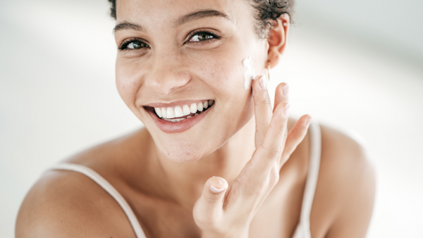 Woman applying moisturizer