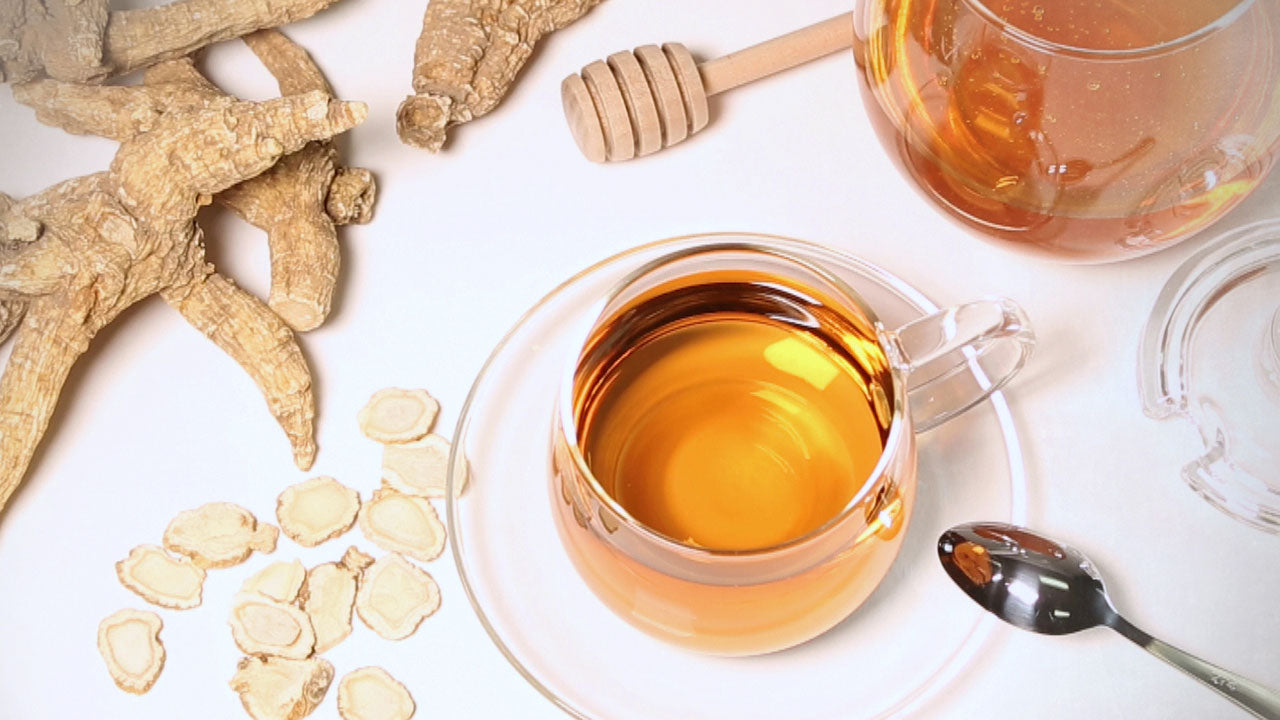 A glass of American Ginseng tea with whole and
sliced American Ginseng root along side.