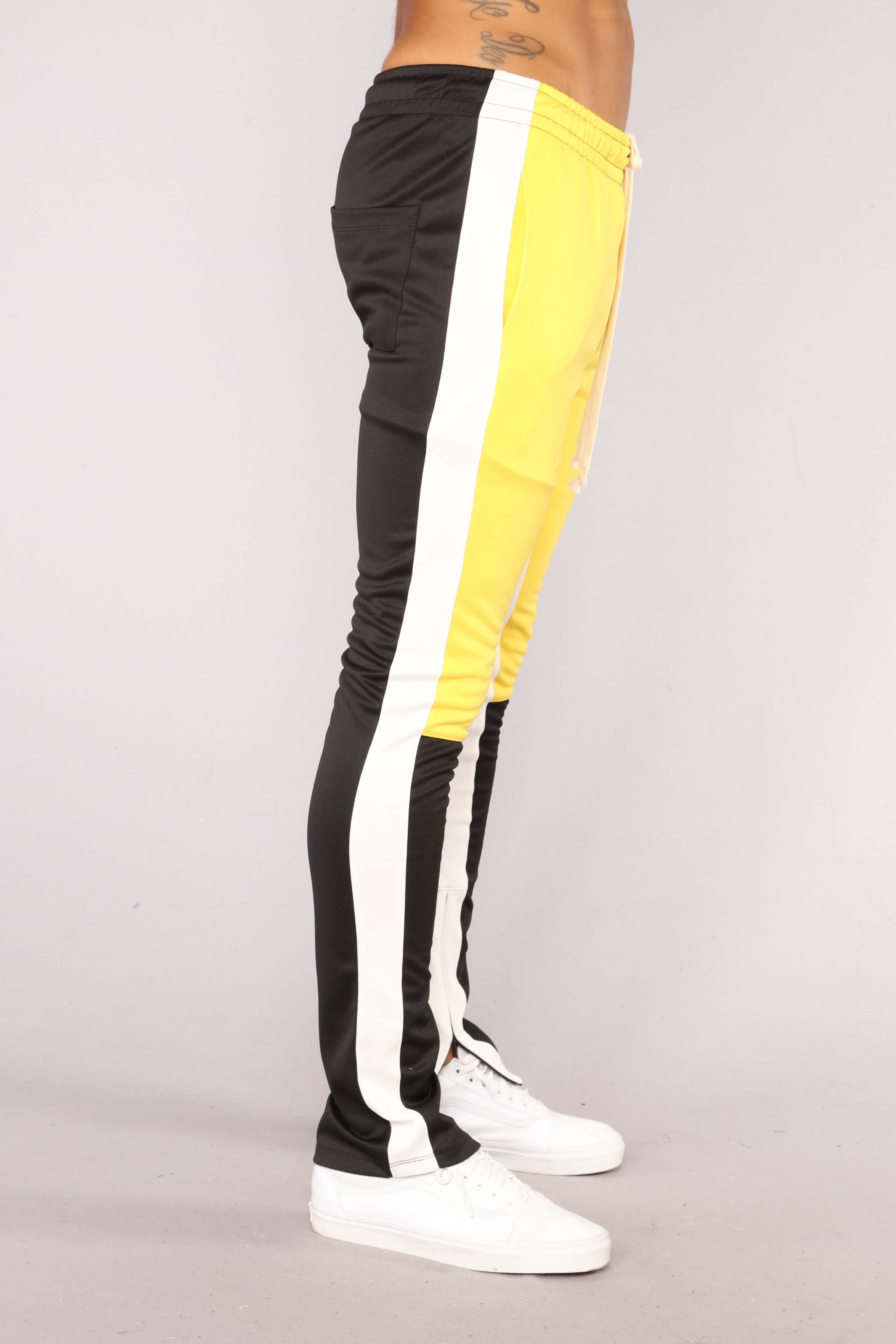 track pants black and yellow