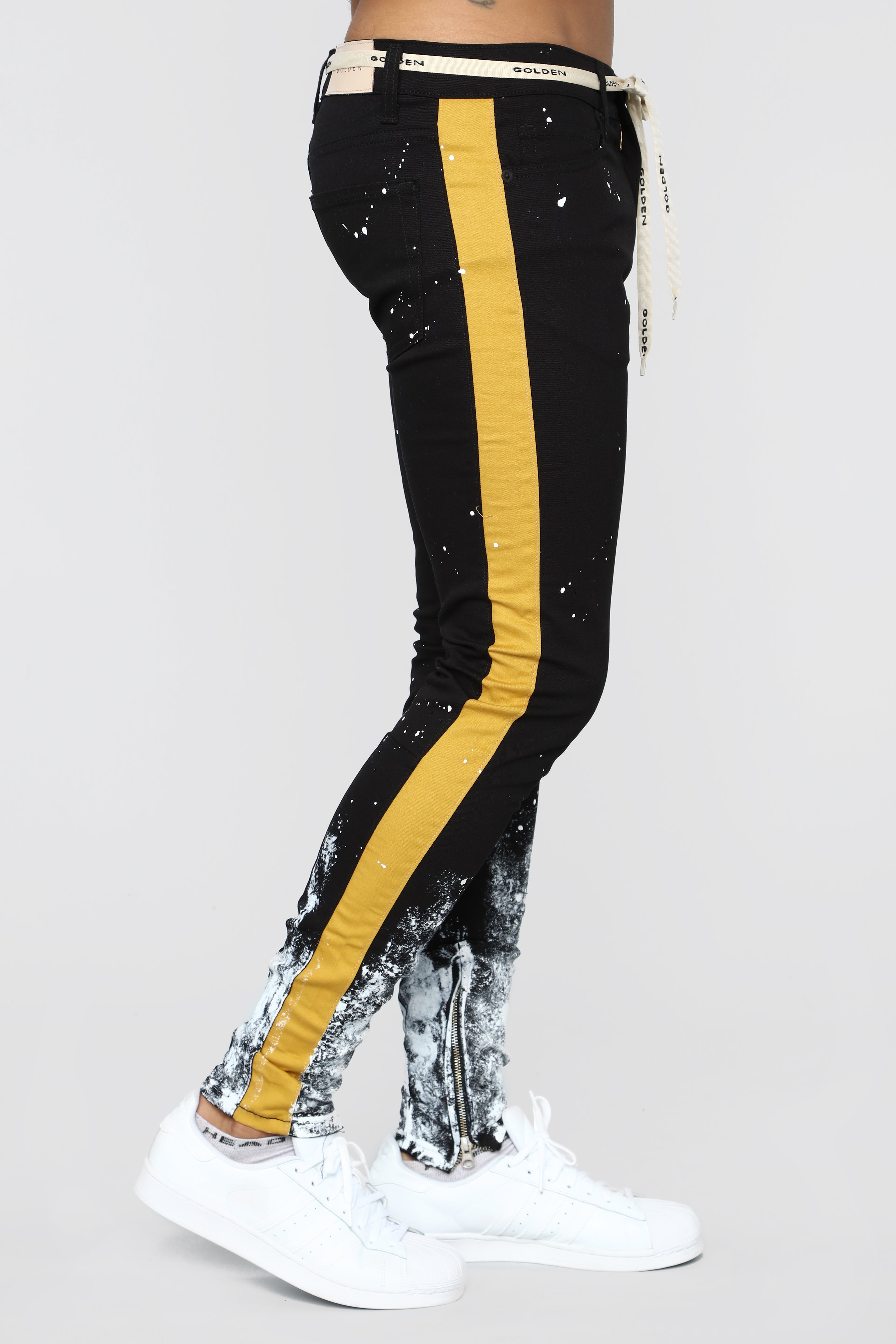 black track pants with yellow stripe