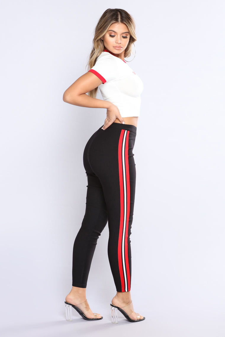 black jeans with red and white stripe