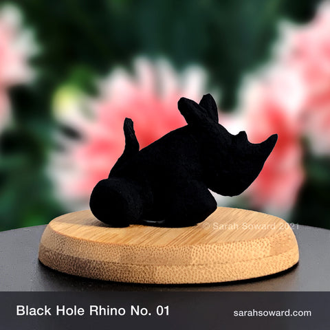 Black Hole Rhino sculpture number 01 on a bamboo stand