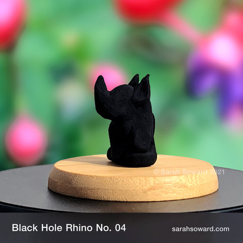 Black Hole Rhino sculpture number 04 on a bamboo stand