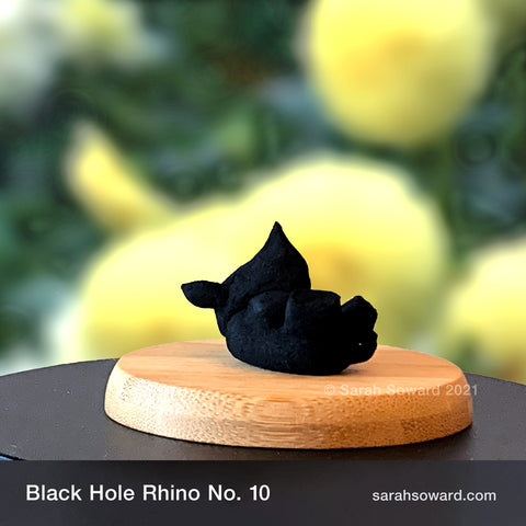 Black Hole Rhino sculpture number 10 on a bamboo stand