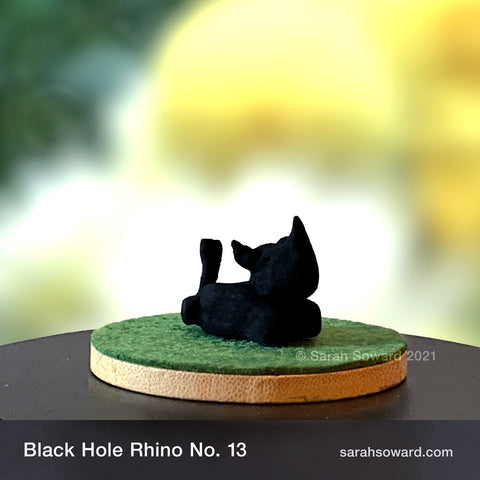 Black Hole Rhino sculpture number 13 on a bamboo stand