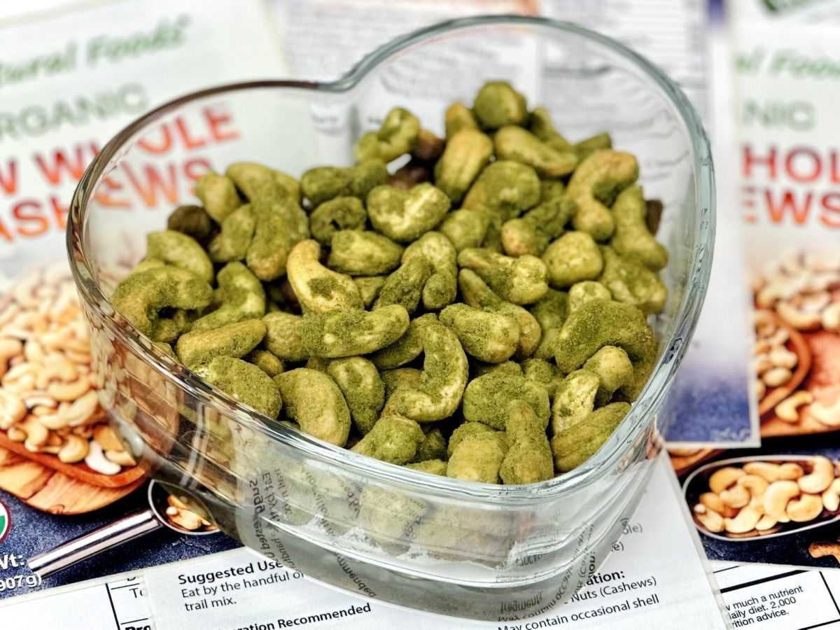 This is a picture of our Cashew Spinach snacks in a glass bowl shaped like a heart, with our ZNF products in the background all on a white background