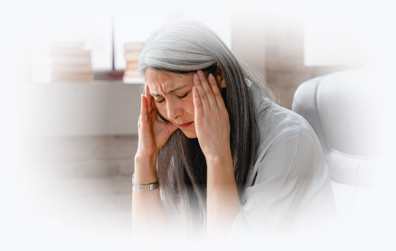 Image of woman with hands on her temples because of head pain