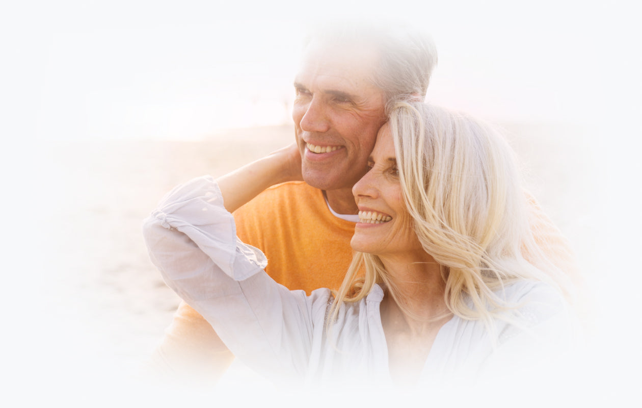 Image of man and woman smiling while looking out into the distance.