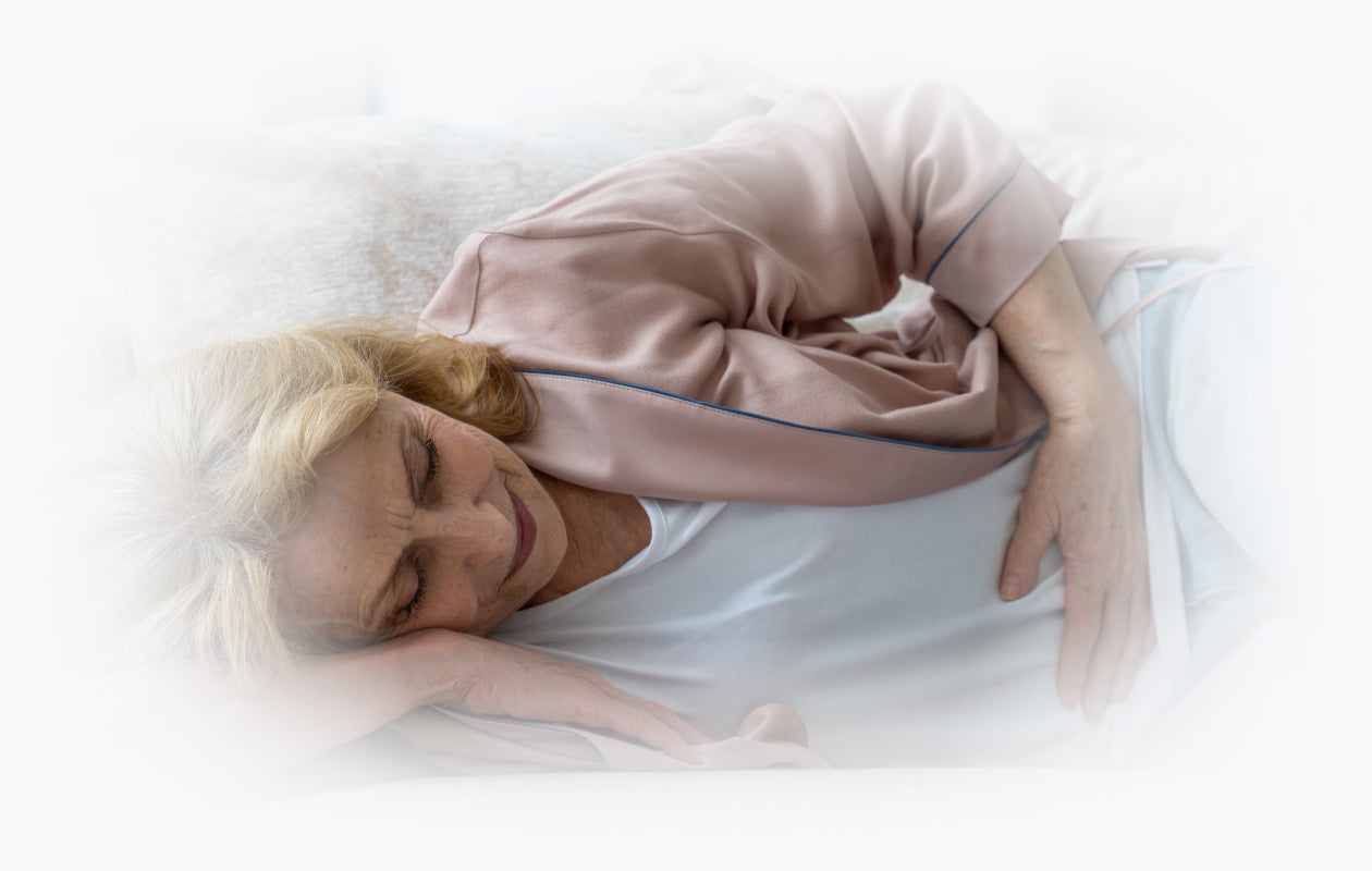 Image of woman lying on side with hand over her tummy and suffering from diarrhea