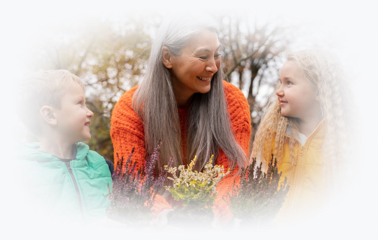 Image of woman and two children holding flowers in hands.