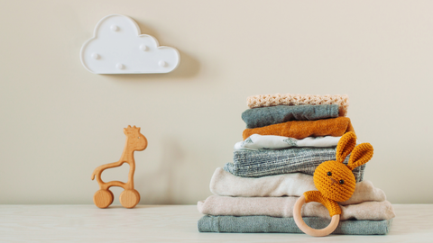 preemie clothes folded in a pile