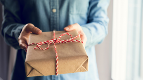 woman giving gift for holidays to nicu nurse