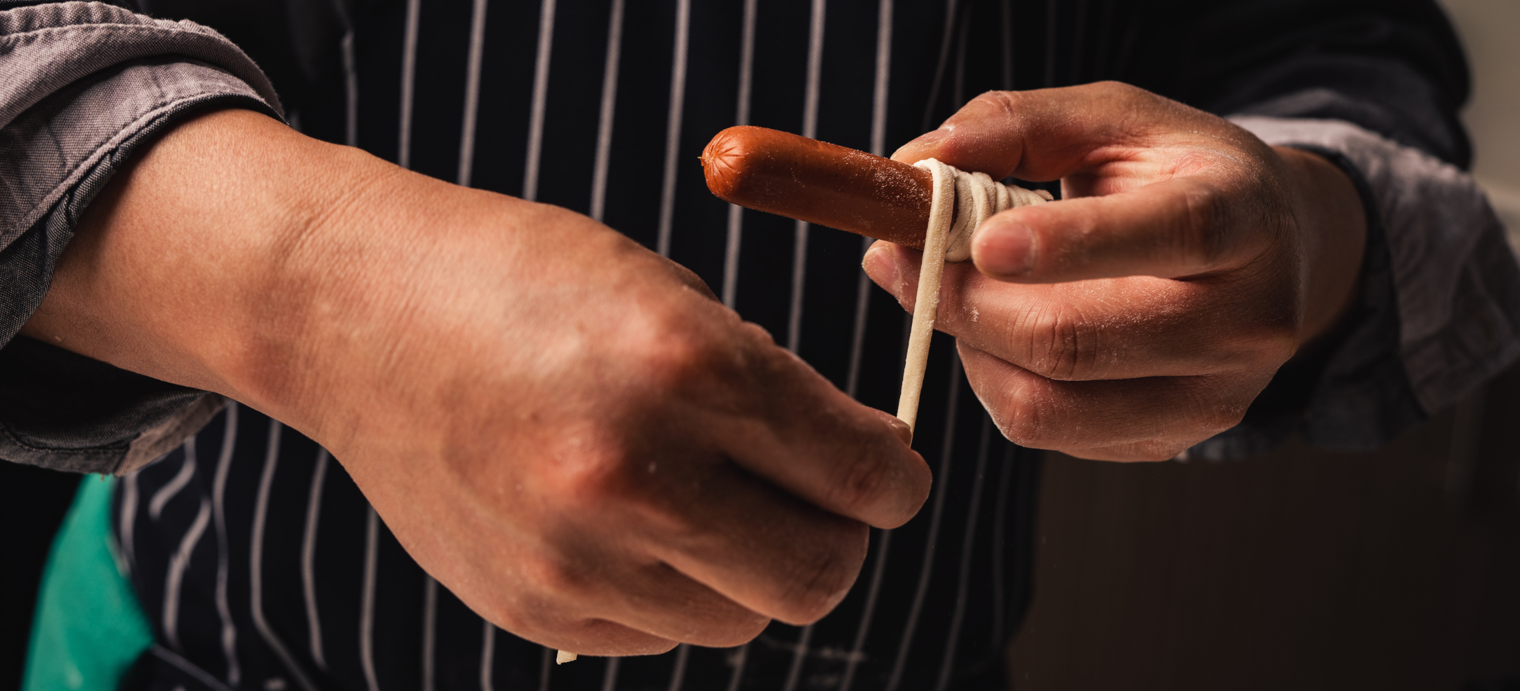 Cuisipro Mummy Hot Dog Recipe for halloween, man wrapping pizza dough around hot dog