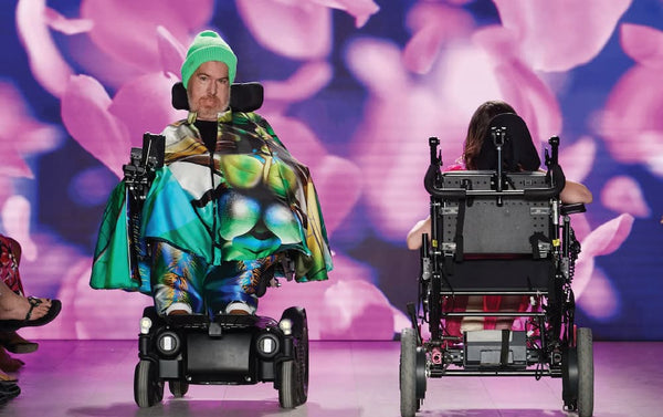 Man modeling on runway in his wheelchair