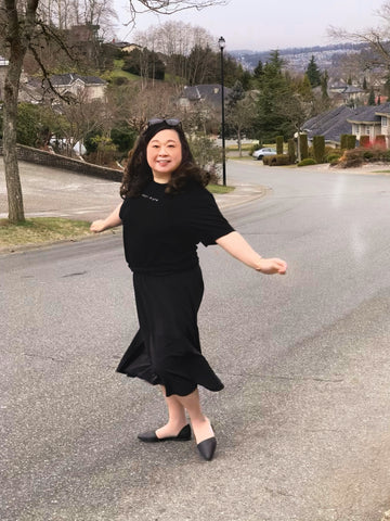 Anne wearing Aille Design Custom Braille T-Shirt “purpose in view” and black flounce skirt twirling