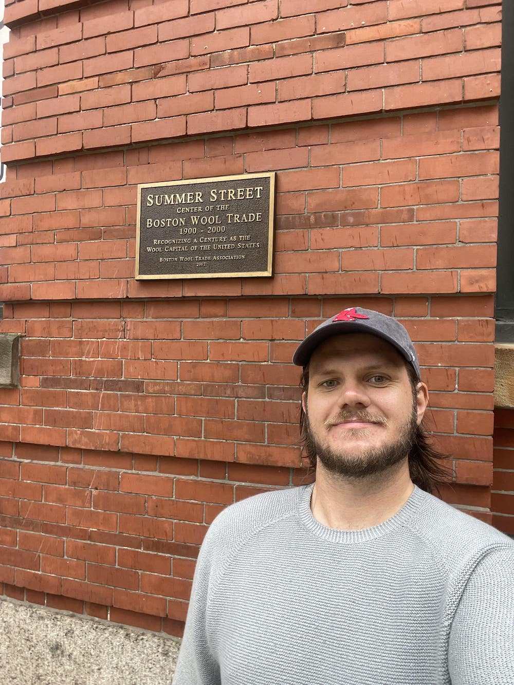 Slater_Wearing_US_Merino_Crew_Neck_Standing_in_Front_of_The_Plaque_Commemorating_the_Boston_Wool_Trade_-_Oliver_Charles.jpg__PID:2d00c9d4-8e72-4992-b6f0-088212e604c2