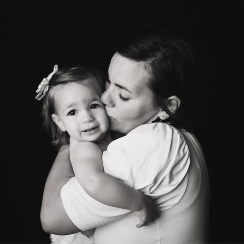 black and white image  mother kissing daughter