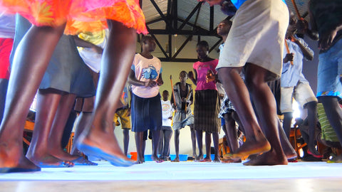 Collecting painted footprints of children dancing in Uganda