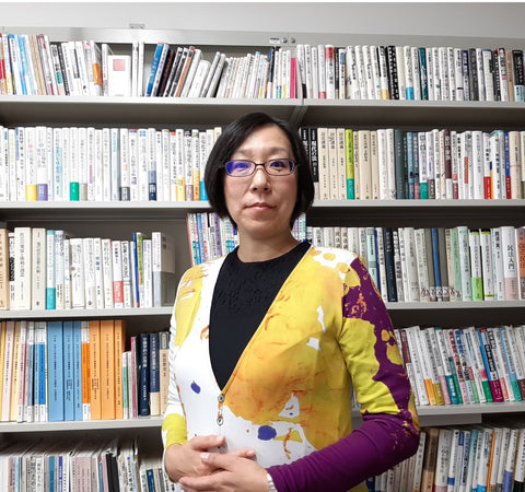 Madoka Miwa in her office wearing the UNISSOGRAFF LADIES CARDIGAN DRESS for UGANDA