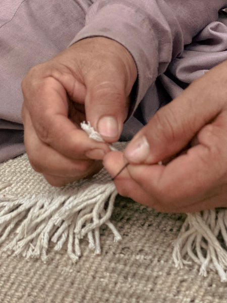 Hand Knotting Being Done by a artisan at imam carpet's factory in Karachi, Pakistan