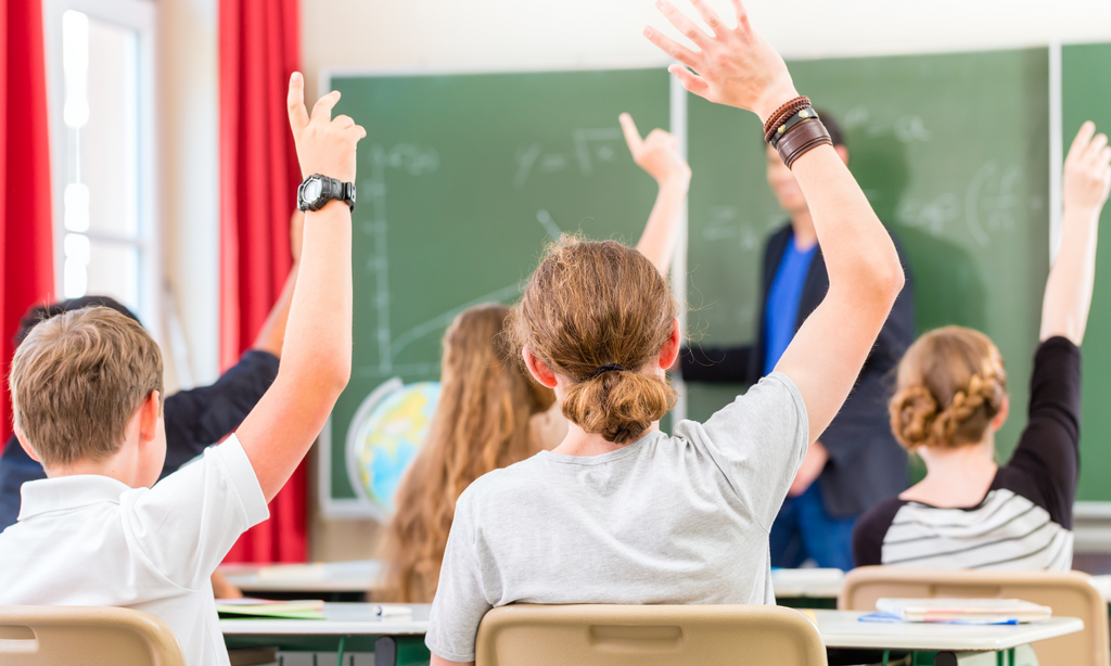 An image showing children putting up their hand but fearing they might get the answer wrong and being laughed at by other kids