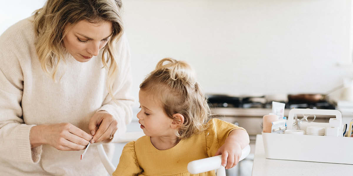 Mother using Manuka honey on child to help health infected cut