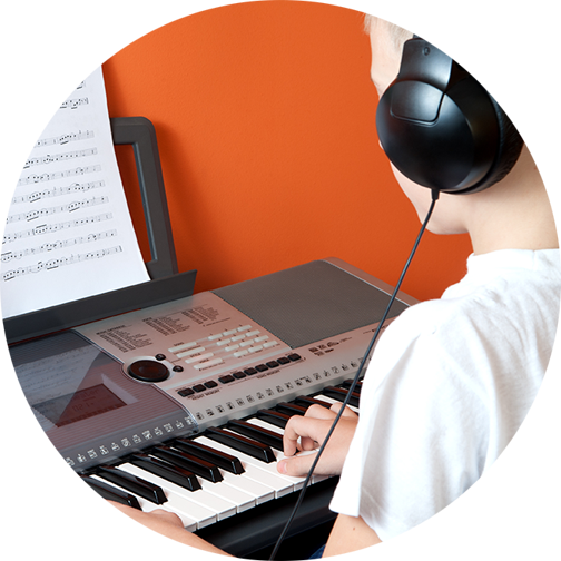 Child playing keyboard with headphones