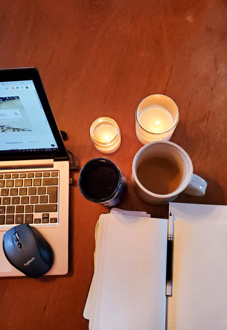 Candles coffee journal on brown wooden table 