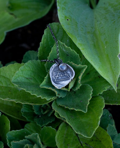silver air sign talisman necklace with green leaves