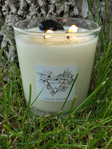 luxury soy candle with crystal nestled in grass for earth signs taurus, virgo, capricorn