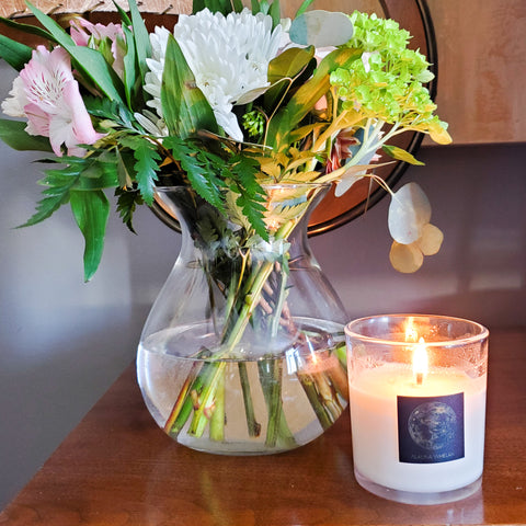 spring altar with fresh cut florals and full moon crystal infused soy intention candle