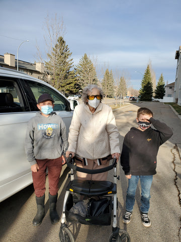 granny and two great grandsons in masks