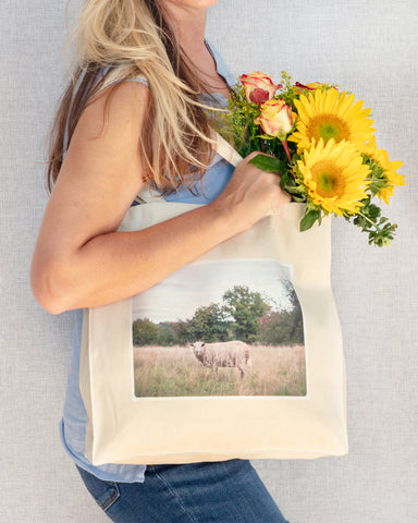 woman with yellow flowers holding cotton canvas tote with sheep