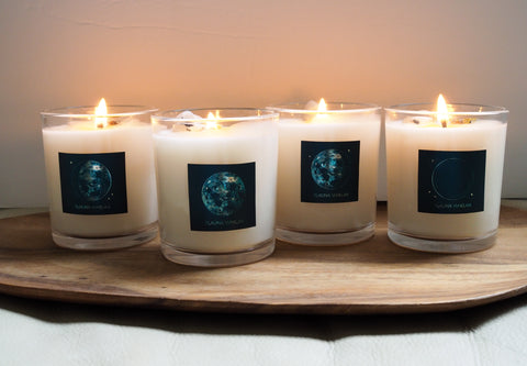 set of four luxury lunar soy candles on wooden tray