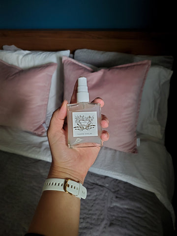 hand holding luxury lavender and crystal infused bed linen mist