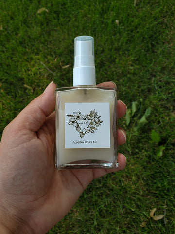 hand holding luxury crystal infused ritual spray
