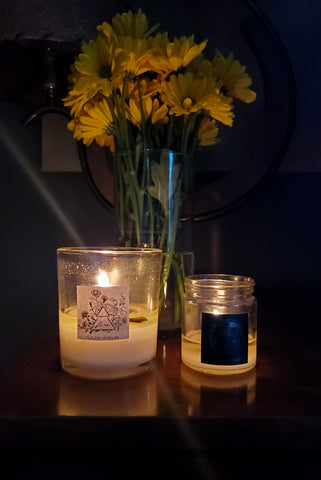 moody lit luxury soy element and lunar candles with fresh yellow florals