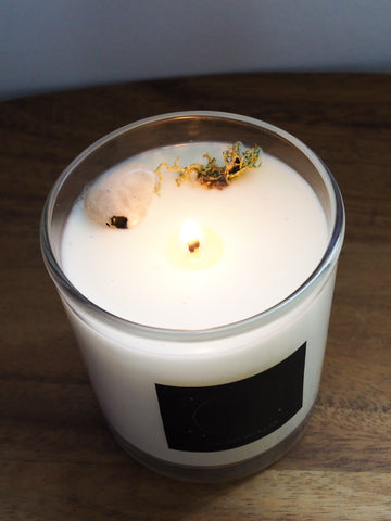 top view of new moon soy crystal infused lunar candle with moonstone and moss