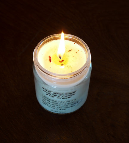 lit soy intention candle on dark background