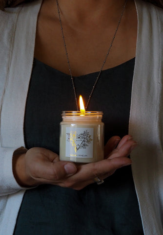 womans hand holding earth sign intention element candle
