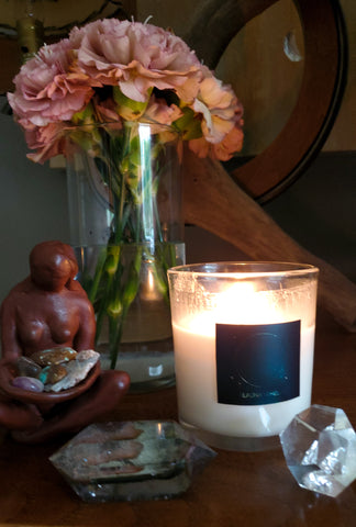 luxury soy candle with fresh flowers crystals and goddess statue