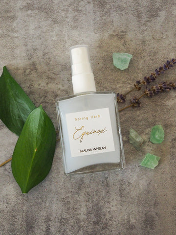 spring equinox aromatic ritual mist with crystals leaves and branches in background