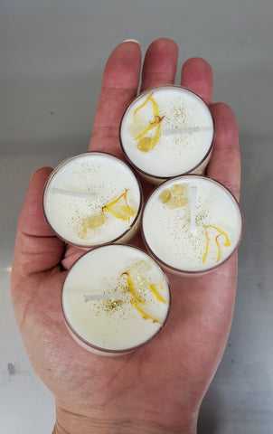 four crystal topped soy tealights on palm of hand