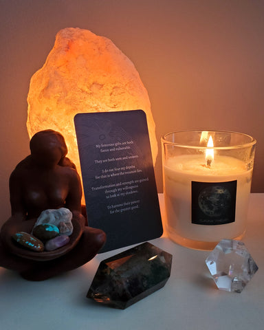 simple altar with crystals, goddess statue, oracle card, and luxury soy full moon candle