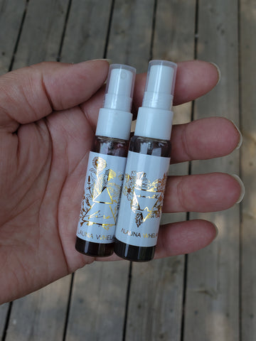 two ritual mists with foil labels in palm of hand